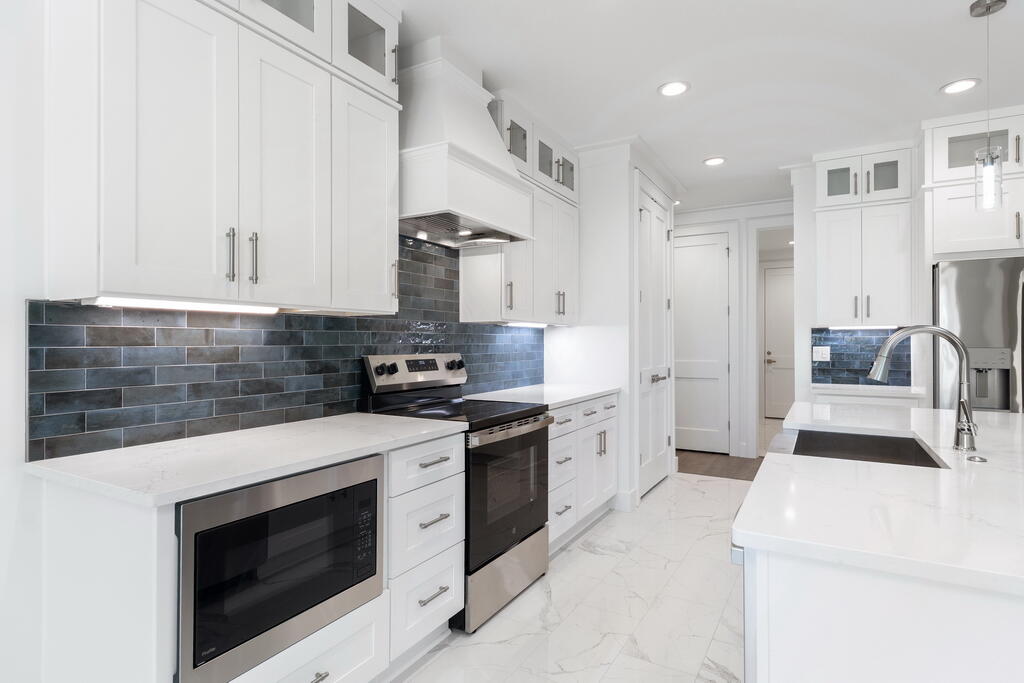 100 Grizzly Street Freeport, FL 32439 - Photo 7 of 65 a kitchen with stainless steel appliances a stove a sink and a refrigerator
