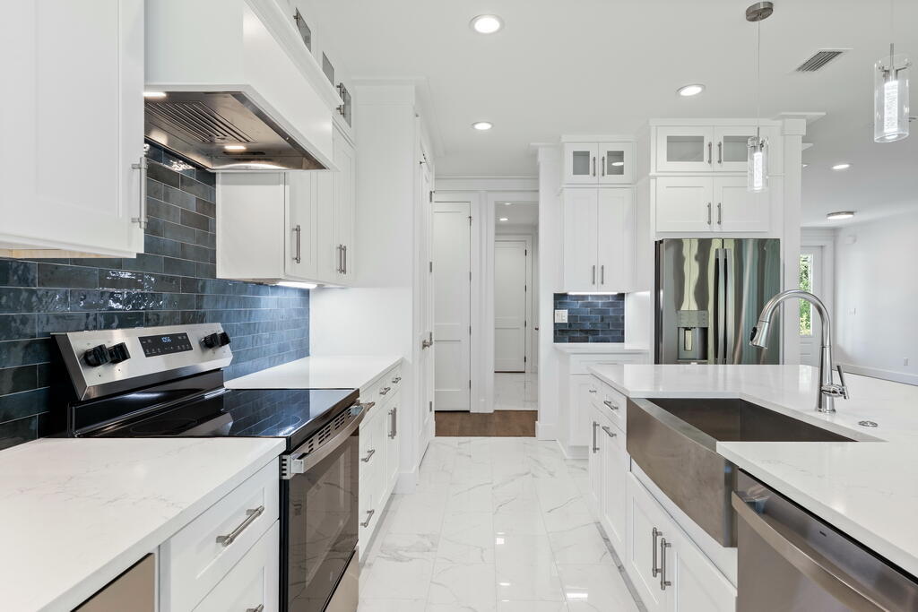 100 Grizzly Street Freeport, FL 32439 - Photo 9 of 65 a kitchen with a sink stove and refrigerator