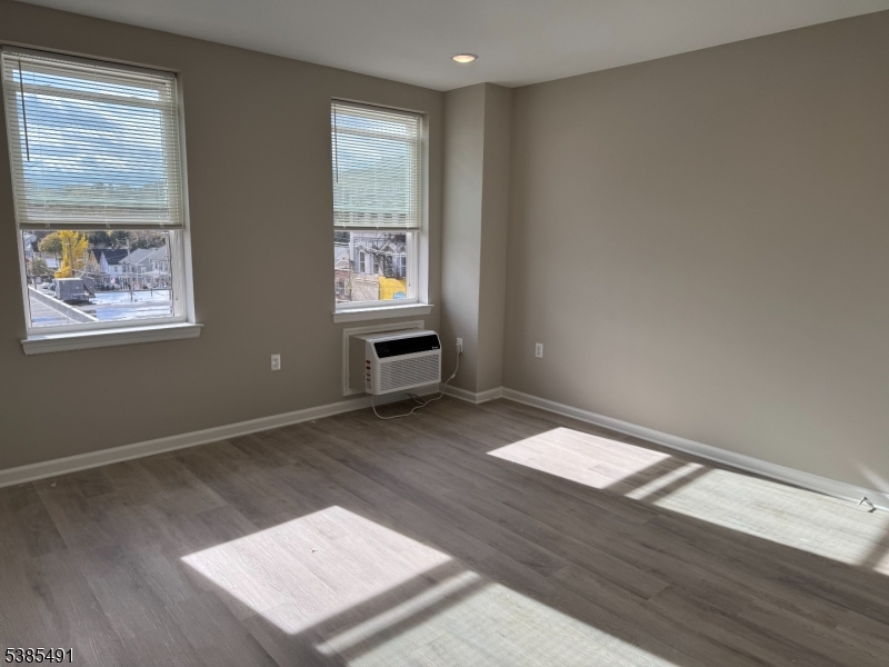 10 East Washington Avenue, Unit 301 Washington, NJ 07882 - Photo 4 of 5 wooden floor in an empty room with a window