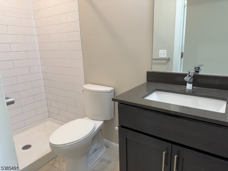 10 East Washington Avenue, Unit 301 Washington, NJ 07882 - Photo 5 of 5 a bathroom with a sink a toilet and shower