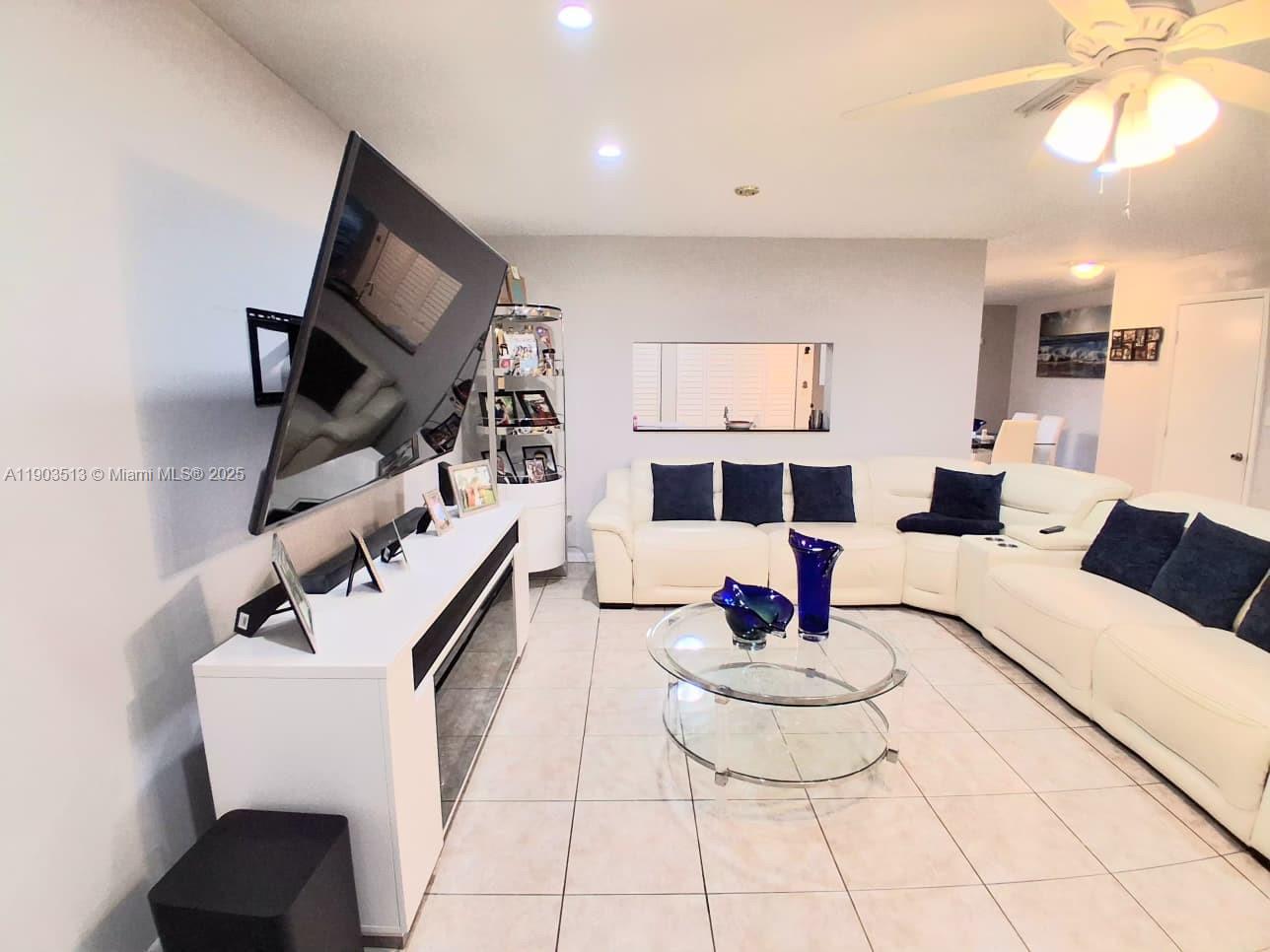 10830 Northwest 8th Street Pembroke Pines, FL 33026 - Photo 12 of 69 a living room with furniture and a flat screen tv