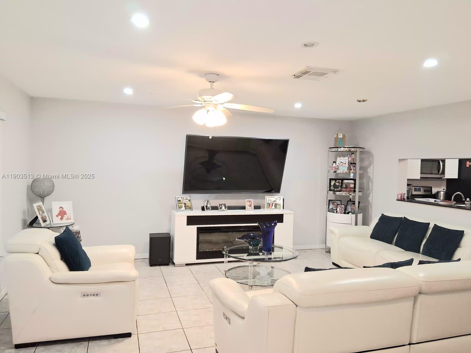 10830 Northwest 8th Street Pembroke Pines, FL 33026 - Photo 13 of 69 a living room with furniture and a flat screen tv