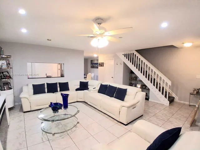 a kitchen with stainless steel appliances granite countertop a sink refrigerator and stove