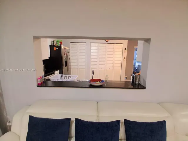 a kitchen with a stove a sink and a refrigerator