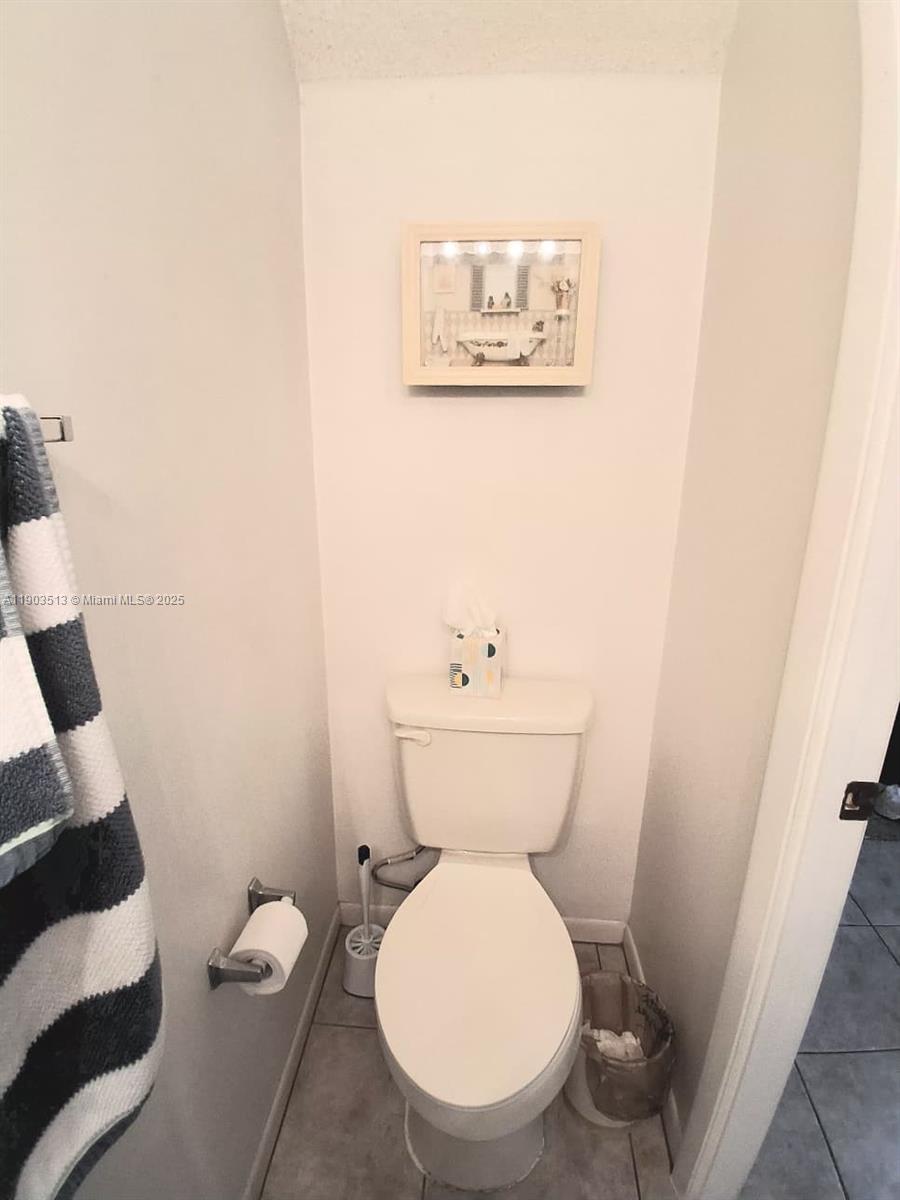 10830 Northwest 8th Street Pembroke Pines, FL 33026 - Photo 21 of 69 a white toilet sitting next to a small sink