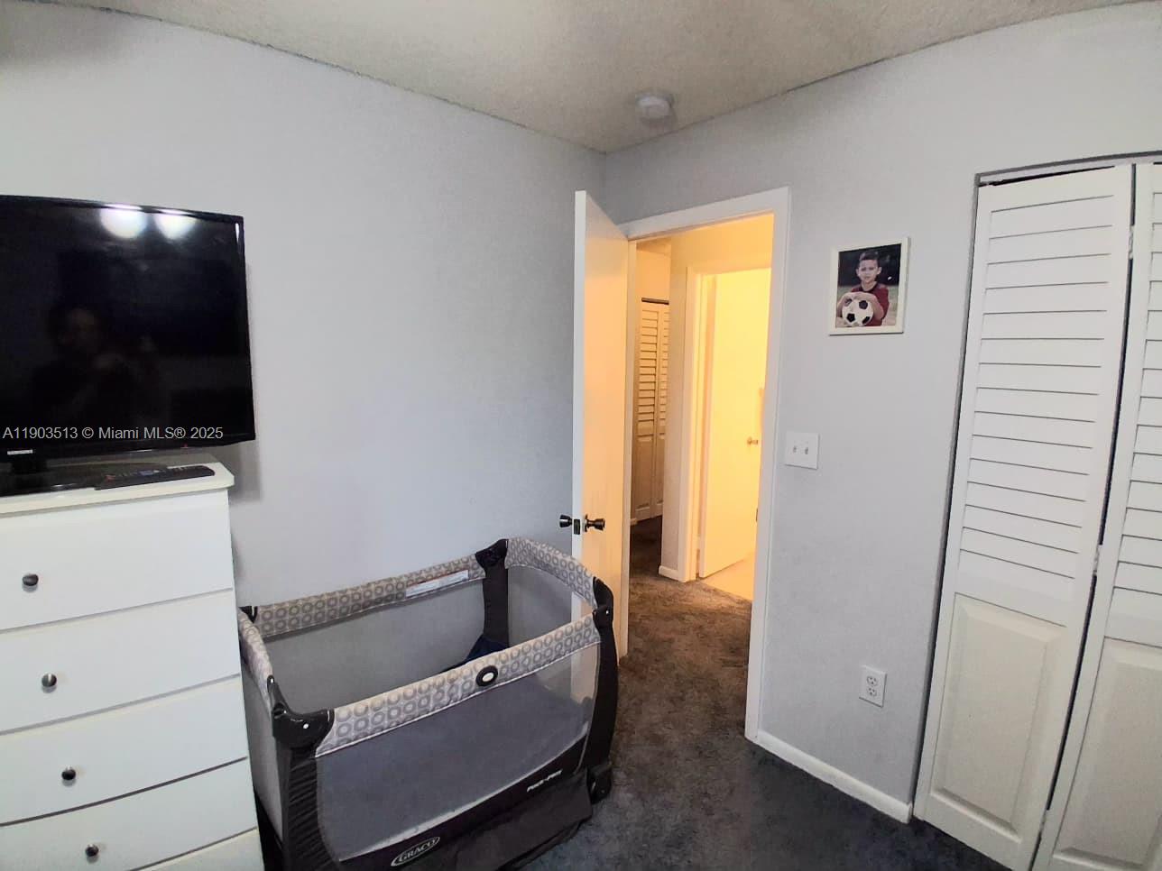 10830 Northwest 8th Street Pembroke Pines, FL 33026 - Photo 26 of 69 a living room with furniture and a flat screen tv