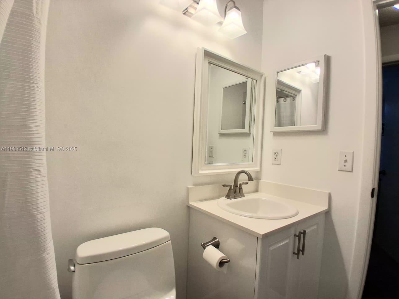10830 Northwest 8th Street Pembroke Pines, FL 33026 - Photo 28 of 69 a bathroom with a sink toilet and mirror
