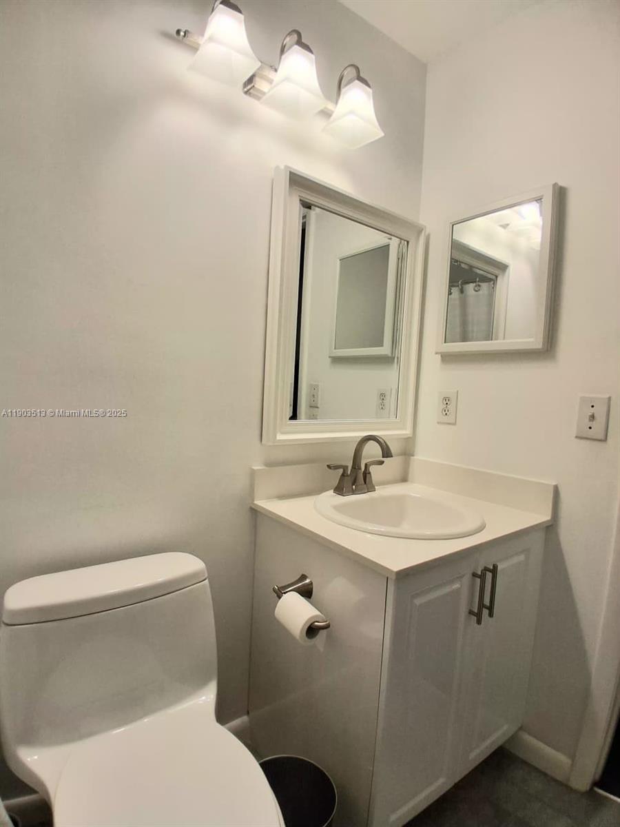 10830 Northwest 8th Street Pembroke Pines, FL 33026 - Photo 31 of 69 a bathroom with a toilet sink and mirror