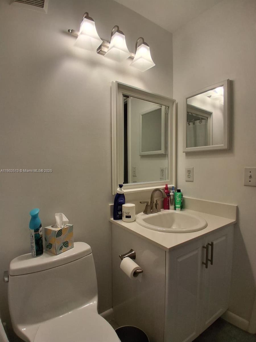 10830 Northwest 8th Street Pembroke Pines, FL 33026 - Photo 33 of 69 a bathroom with a sink a toilet and mirror