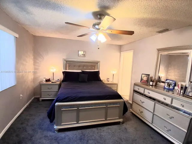 a view of a patio with a table chairs and a backyard