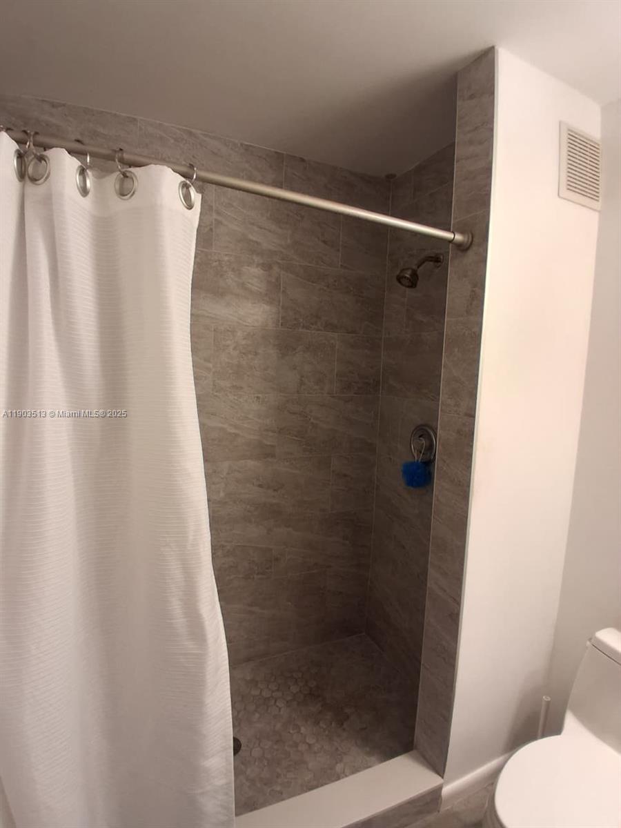 10830 Northwest 8th Street Pembroke Pines, FL 33026 - Photo 39 of 69 a bathroom with a shower and a toilet