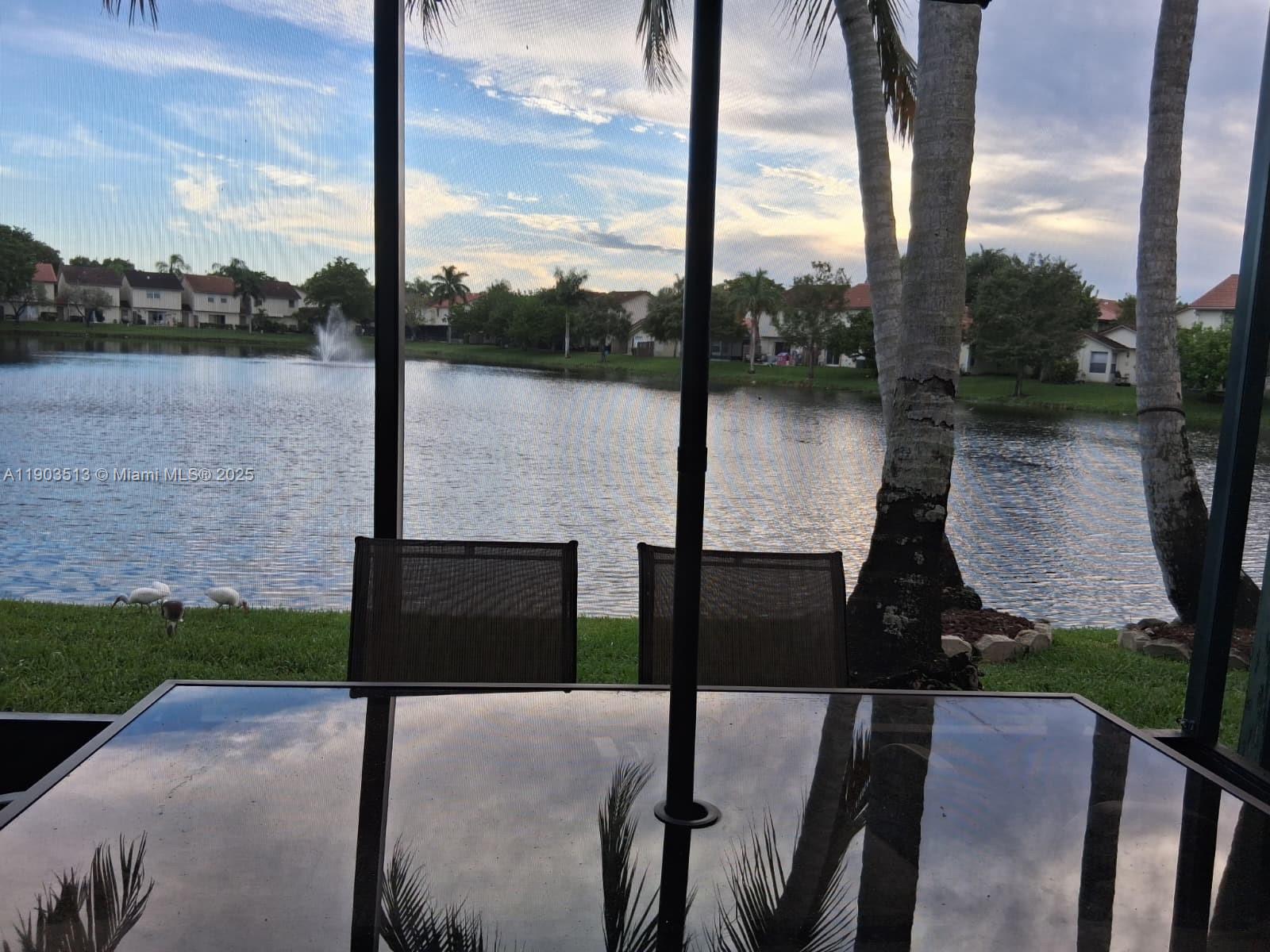 10830 Northwest 8th Street Pembroke Pines, FL 33026 - Photo 52 of 69 a lake view with table and chairs