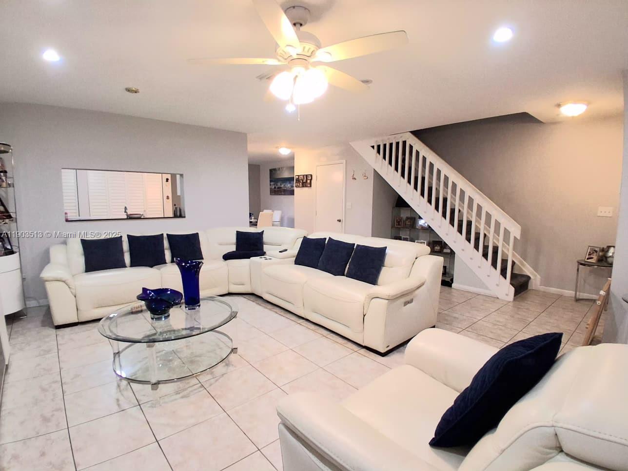 10830 Northwest 8th Street Pembroke Pines, FL 33026 - Photo 10 of 69 a living room with furniture and a chandelier