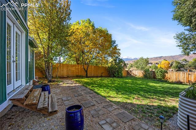 103 Saddlemountain Road Colorado Springs, CO 80919 - Photo 11 of 30 Fenced backyard featuring a patio, french doors, and a mountain view