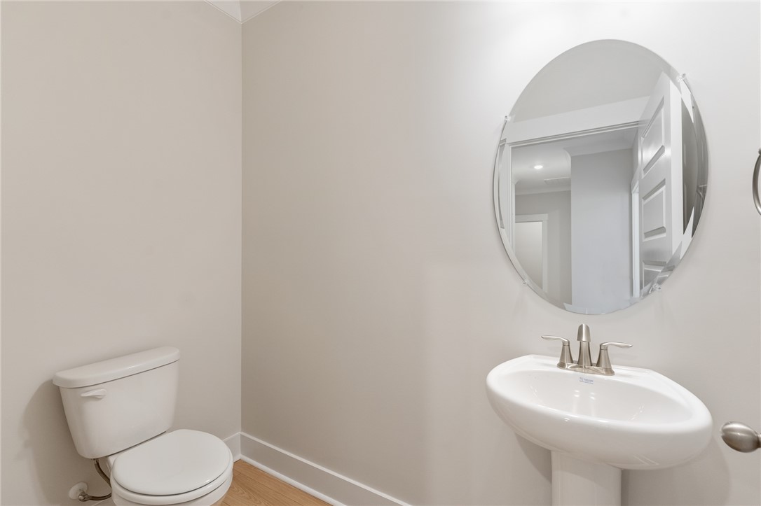203 Timothy Court Anderson, SC 29621 - Photo 34 of 40 A pristine powder room featuring a classic pedestal sink and essential fixtures.