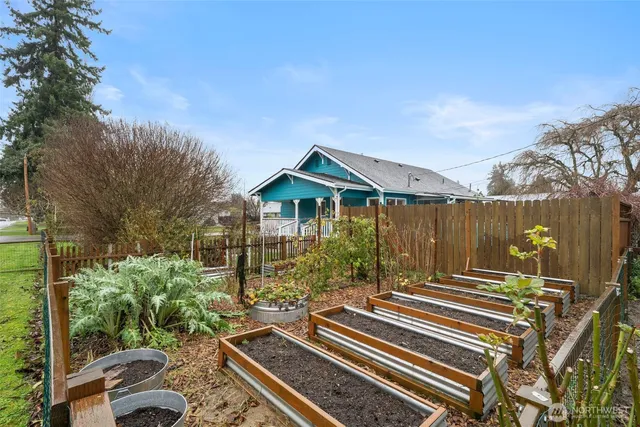 a view of backyard with table and chairs and potted plants