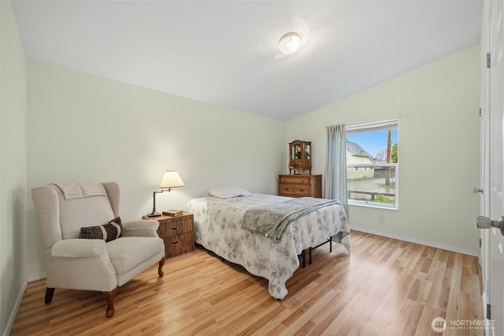 0 Jennings Street Sedro-Woolley, WA 98284 - Photo 32 of 40 a bedroom with a bed wooden floor and lamp