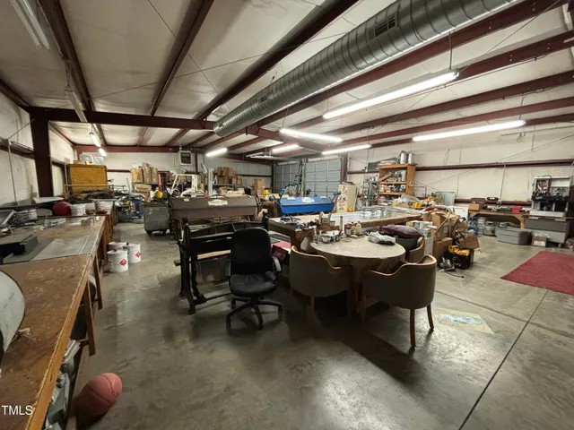 a view of a patio with table and chairs