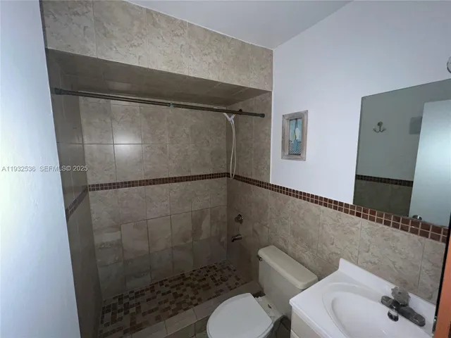 a bathroom with a shower and toilet