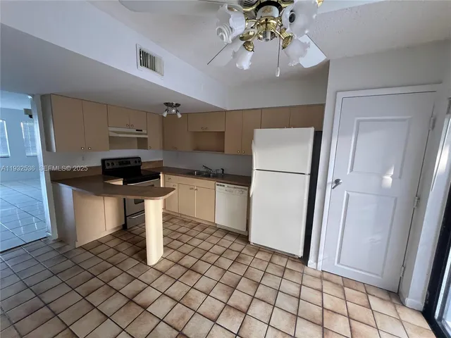 a kitchen with a sink and a refrigerator