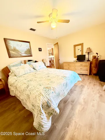 a view of a room with wooden floor and floor to ceiling windows