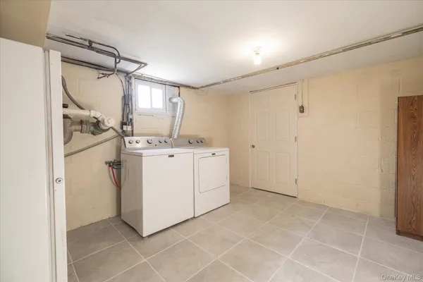 a utility room with cabinets washer and dryer