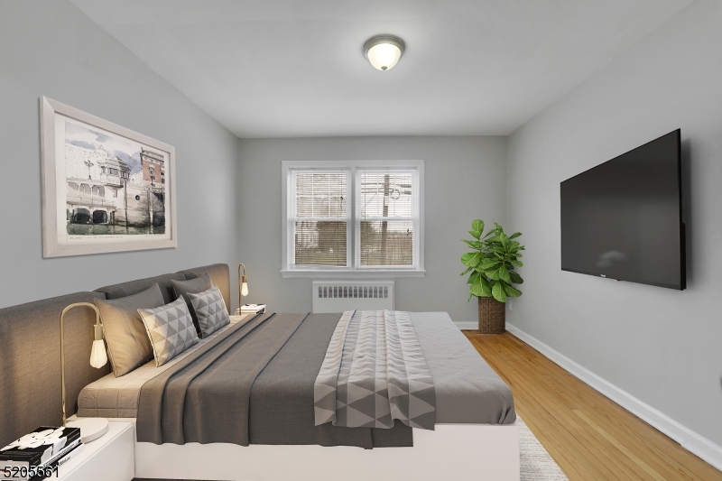 495 Main Street, Unit B 2 Chatham, NJ 07928 - Photo 21 of 22 a bedroom with a bed and a flat screen tv