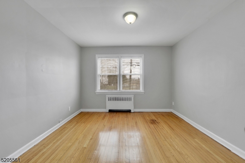 495 Main Street, Unit B 2 Chatham, NJ 07928 - Photo 6 of 22 an empty room with wooden floor and windows