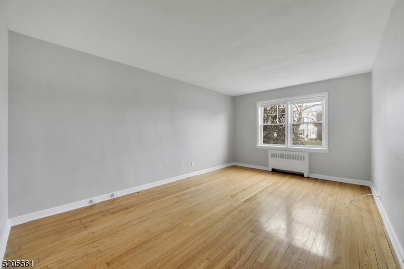 495 Main Street, Unit B 2 Chatham, NJ 07928 - Photo 7 of 22 a view of an empty room with wooden floor and a window