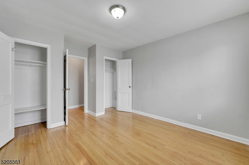 495 Main Street, Unit B 2 Chatham, NJ 07928 - Photo 9 of 22 a view of an empty room with wooden floor and a window