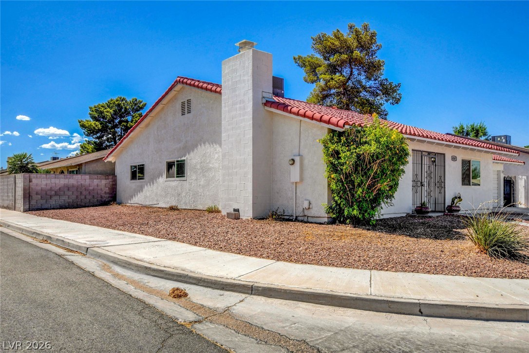 4367 South Mojave Road Las Vegas, NV 89121 - Photo 3 of 53 A well-maintained stucco home with a distinctive red tile roof, complemented by natural desert landscaping.