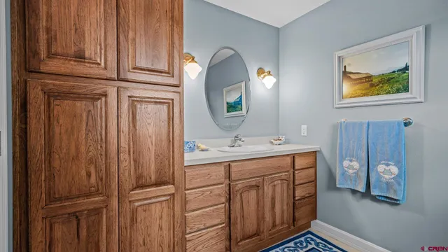 a bathroom with a sink vanity mirror and toilet