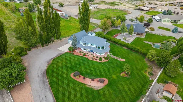 an aerial view of ocean with residential houses with outdoor space and swimming pool
