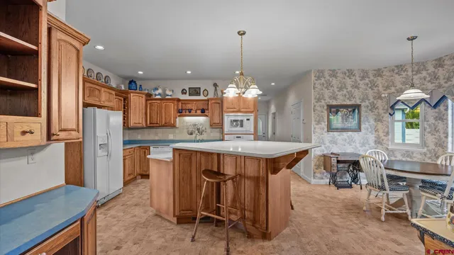 a living room with furniture fireplace and a large window
