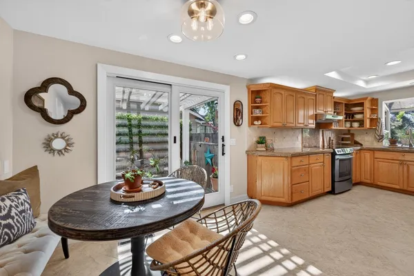 a kitchen with stainless steel appliances granite countertop a refrigerator a sink and a stove