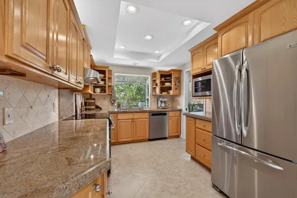 a kitchen with stainless steel appliances granite countertop a sink and cabinets