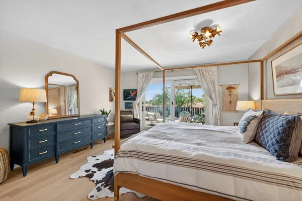 a bedroom with two beds and painting on the wall