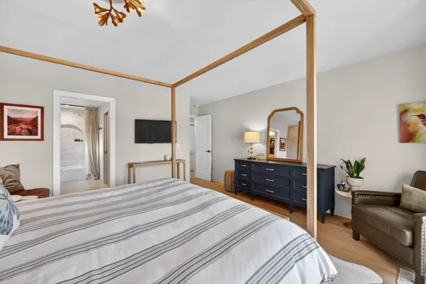 a bedroom with a bed and flat screen tv