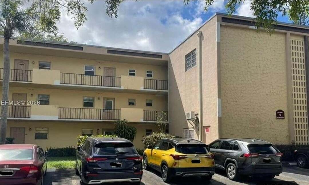 100 Ashbury Road, Unit 206 Hollywood, FL 33024 - Photo 1 of 23 a front view of a house with cars parked