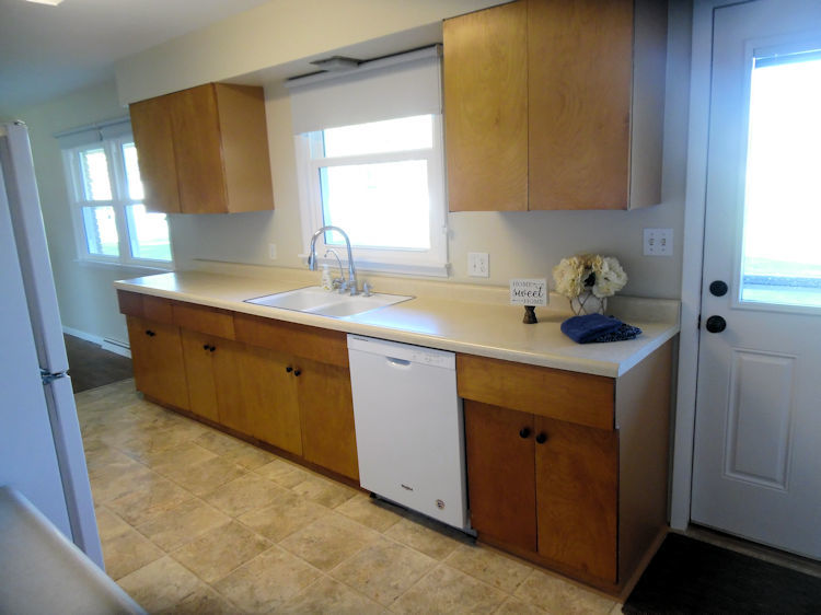 1111 10th Avenue Rochelle, IL 61068 - Photo 2 of 17 a kitchen with a sink cabinets and a window