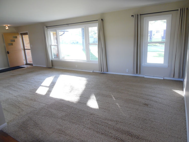 1111 10th Avenue Rochelle, IL 61068 - Photo 5 of 17 an empty room with wooden floor and windows