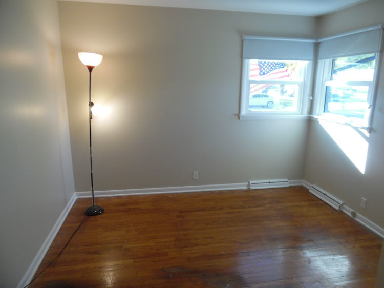 1111 10th Avenue Rochelle, IL 61068 - Photo 7 of 17 an empty room with wooden floor and windows