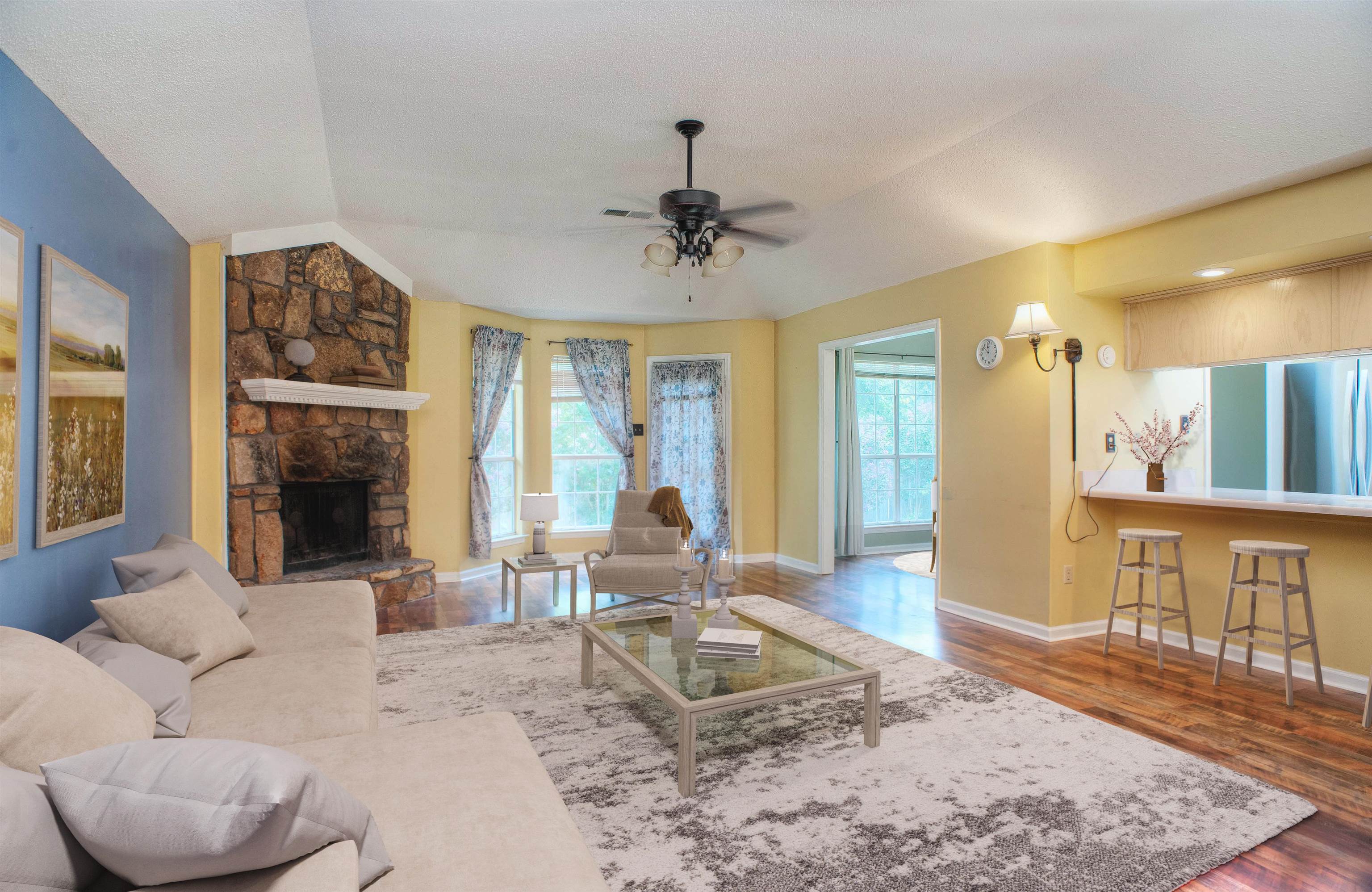 6652 Elmore Ridge Lane Memphis, TN 38134 - Photo 1 of 19 Spacious 24x16 Great Room features Corner Stone Fireplace with Raised Hearth, Ceiling Fan in Coffered Ceiling, Beautiful Updated Flooring and Bay Window. This photo is virtually staged.
