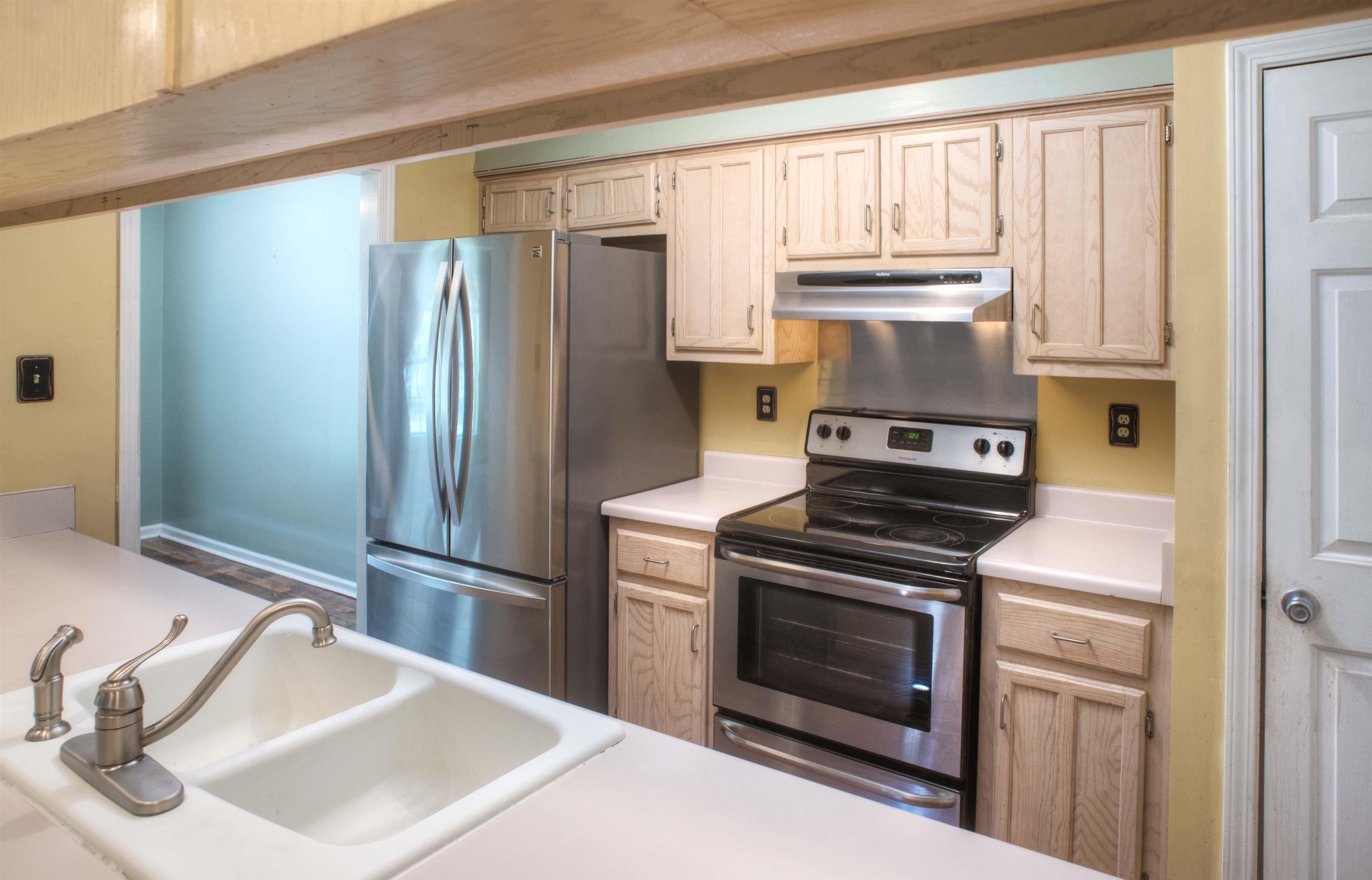 6652 Elmore Ridge Lane Memphis, TN 38134 - Photo 4 of 19 Kitchen features Updated Floor, 19 Cabinets plus Pantry, and Stainless Appliances including Smooth Top Range/Oven, dishwasher, and Double-Door Fridge with Freezer Drawer which stays with the house!