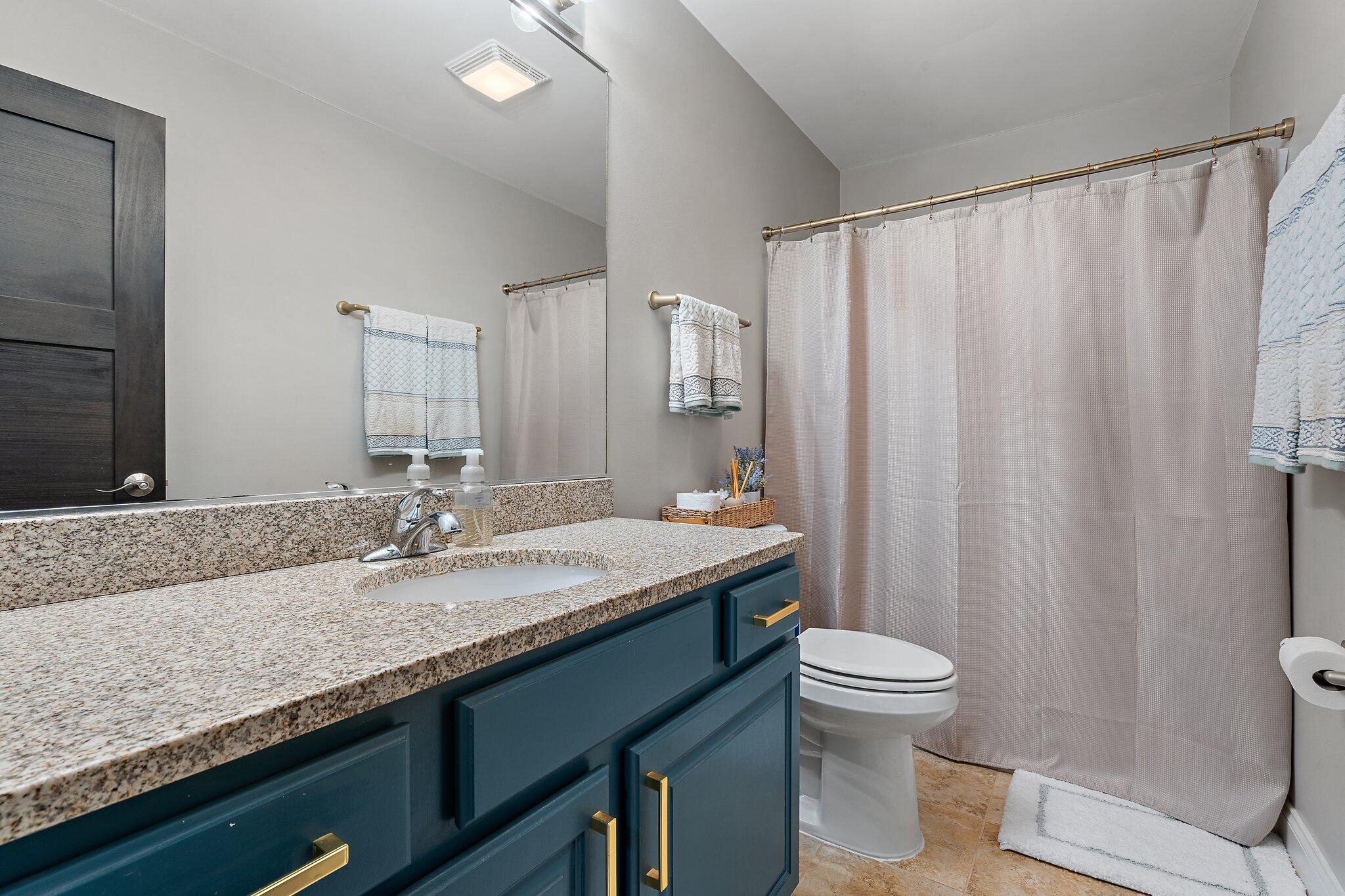 105 Madison Street Valparaiso, IN 46385 - Photo 19 of 29 a bathroom with a granite countertop sink and a mirror