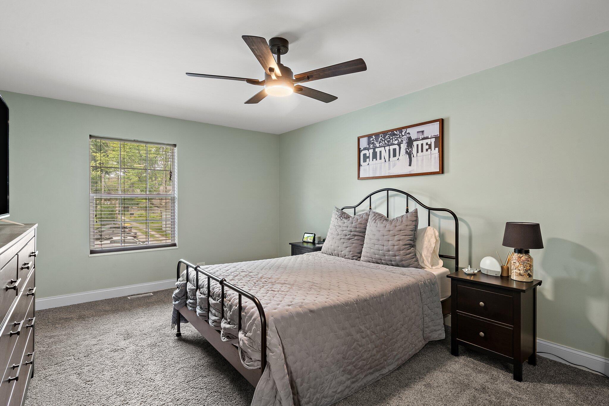 105 Madison Street Valparaiso, IN 46385 - Photo 20 of 29 a bedroom with a bed and a chandelier