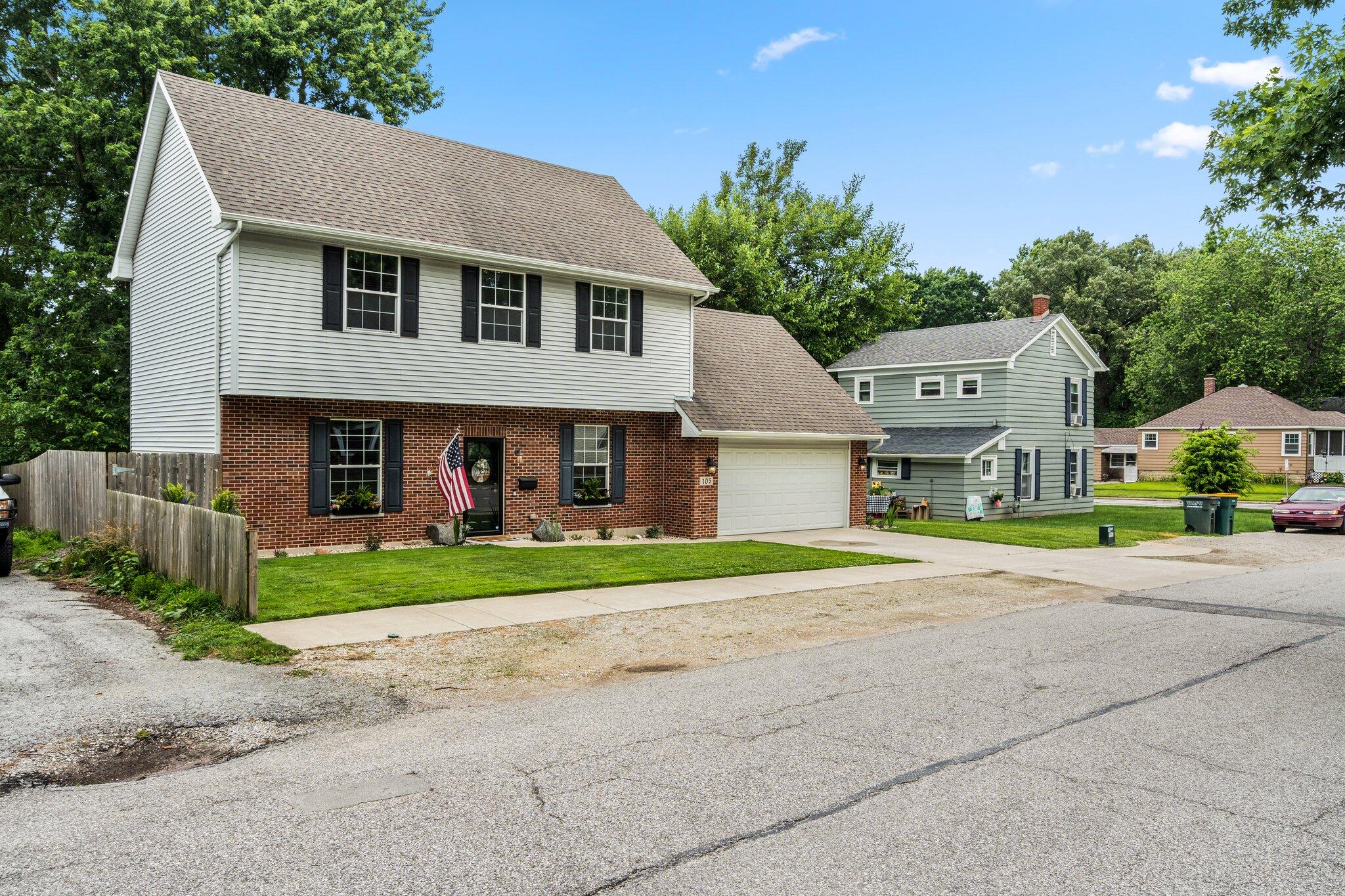 105 Madison Street Valparaiso, IN 46385 - Photo 2 of 29 a front view of a house with a yard and garage