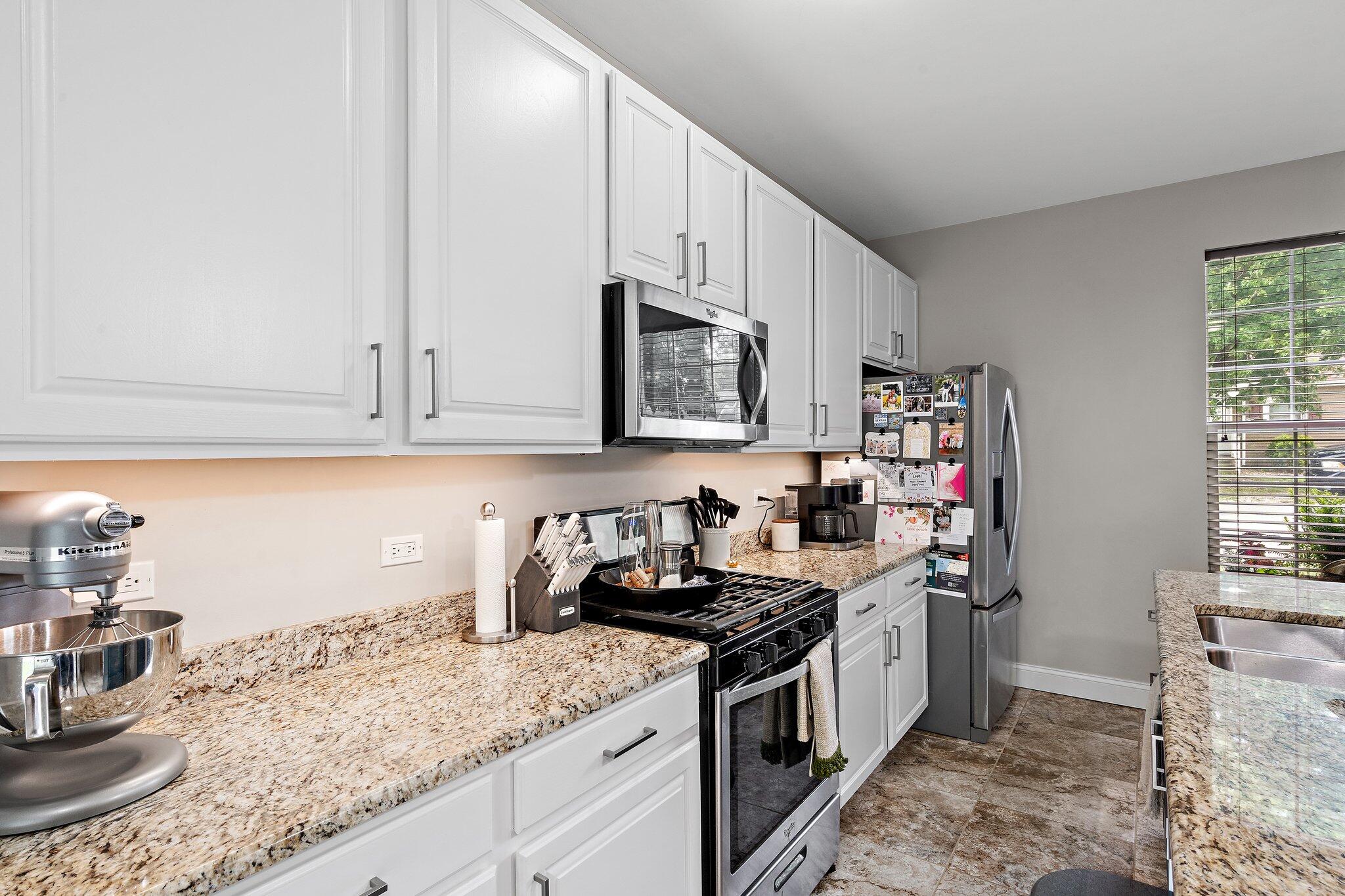 105 Madison Street Valparaiso, IN 46385 - Photo 10 of 29 a kitchen with granite countertop a sink a stove and cabinets