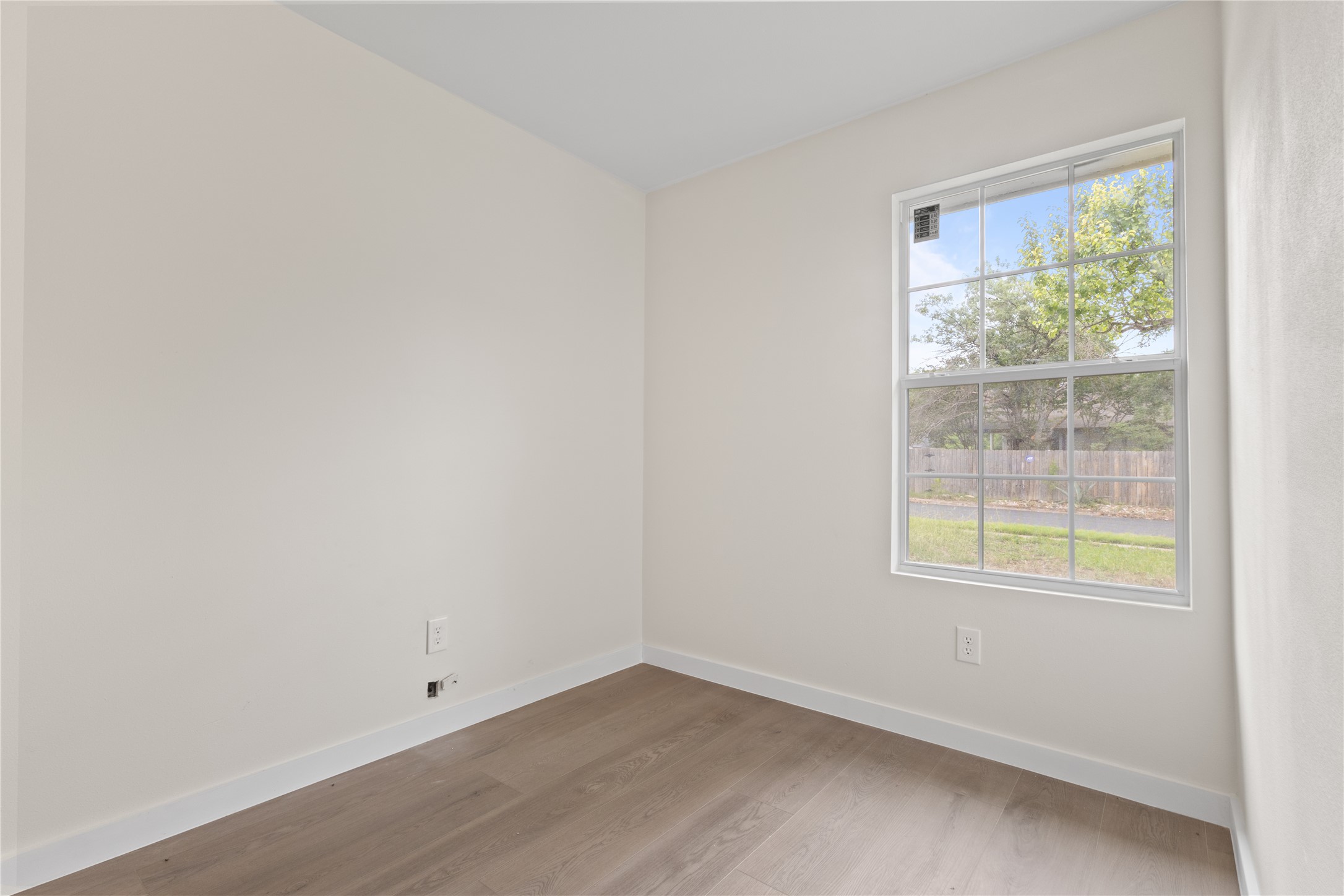 8528 Cornwall Drive Austin, TX 78748 - Photo 16 of 24 Unfurnished room with wood finished floors and baseboards