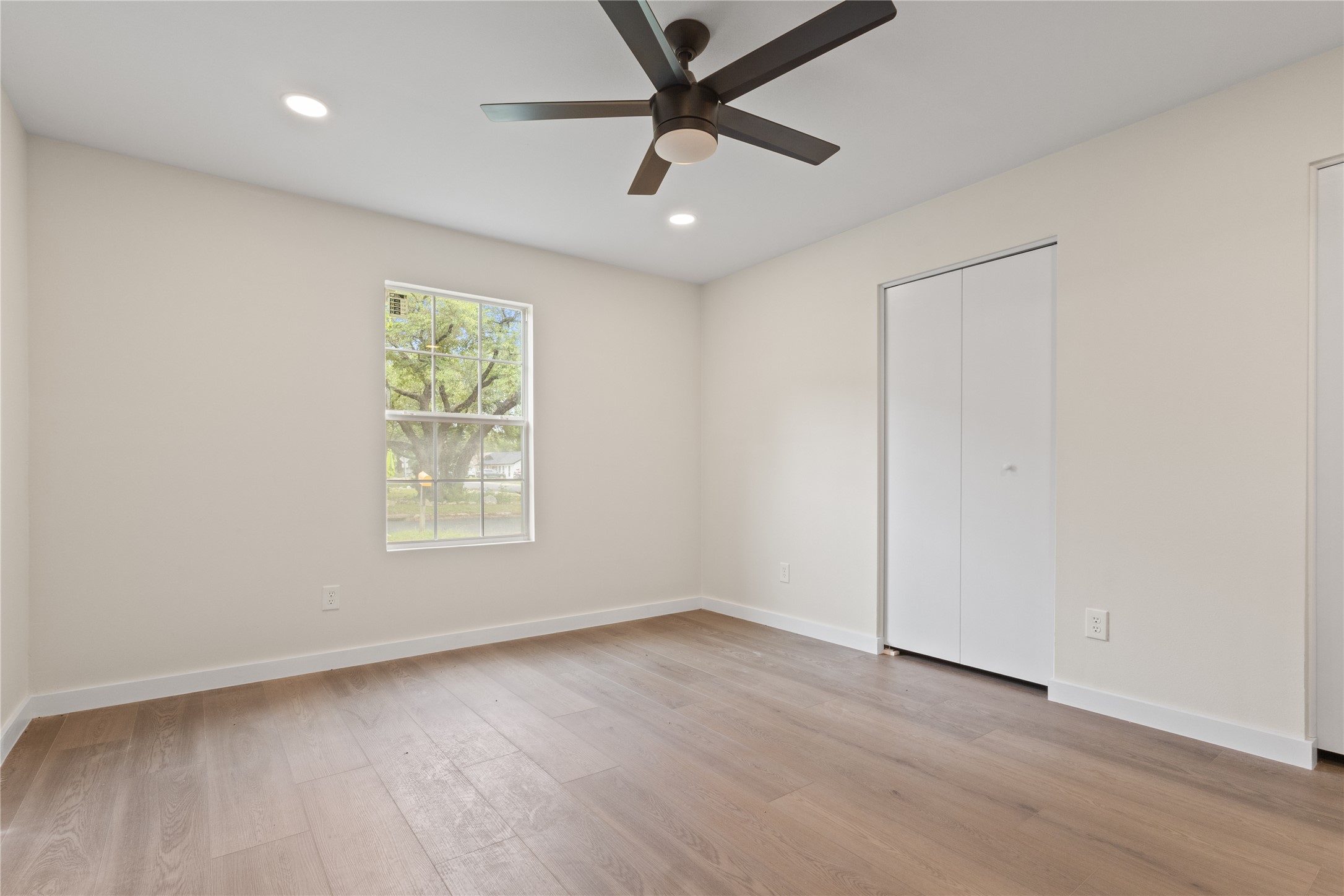 8528 Cornwall Drive Austin, TX 78748 - Photo 19 of 24 Unfurnished bedroom with light wood-type flooring, baseboards, recessed lighting, and ceiling fan